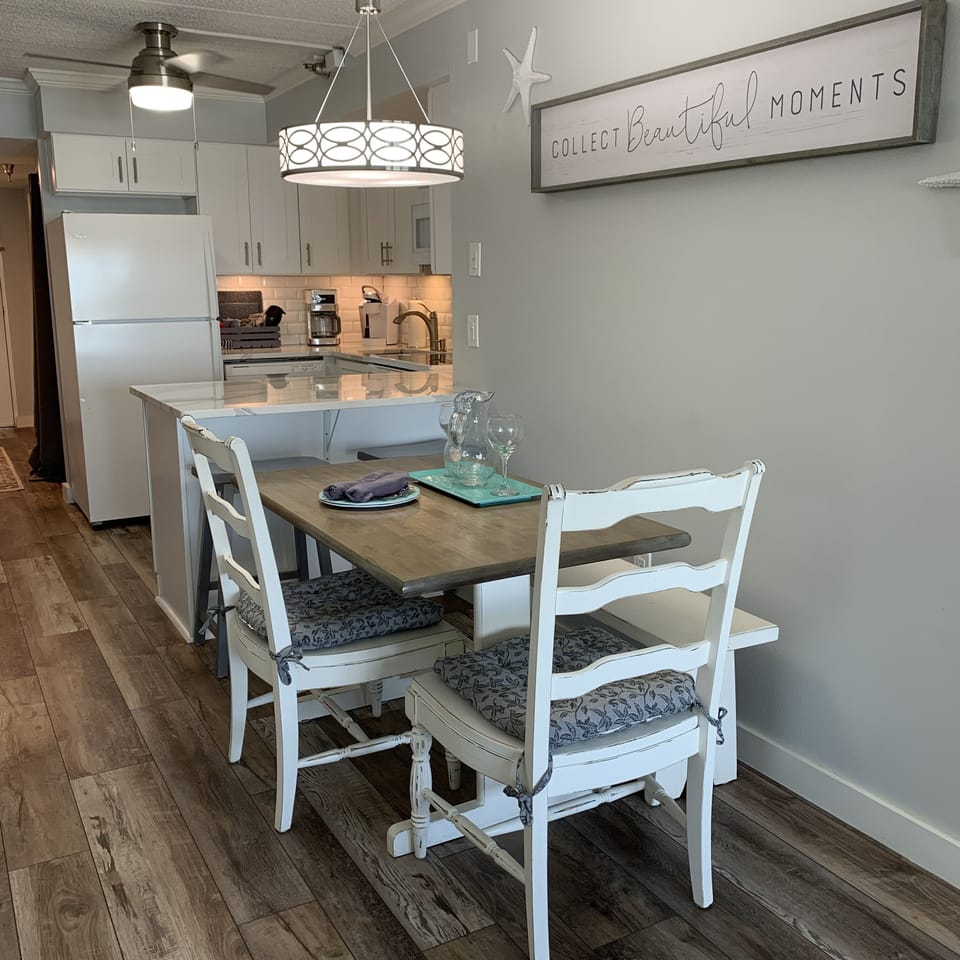 Open kitchen-dining-living area. Expanded counter w/bar stools.