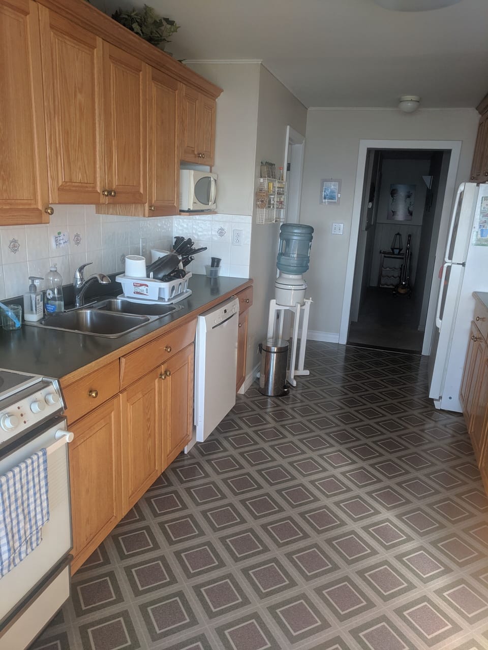 Kitchen with fridge, stove, oven, dishwasher, microwave.