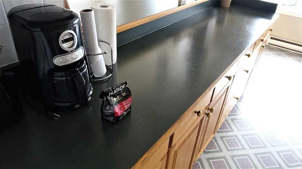 Long countertop island in kitchen
