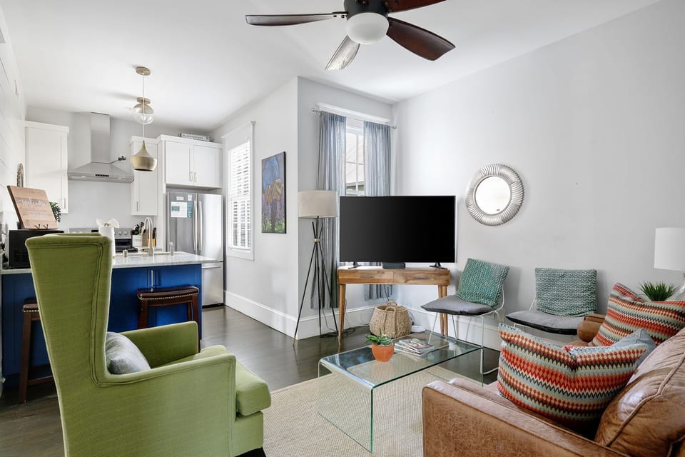 Vibrant throw pillows and abstract art add personality to the space.