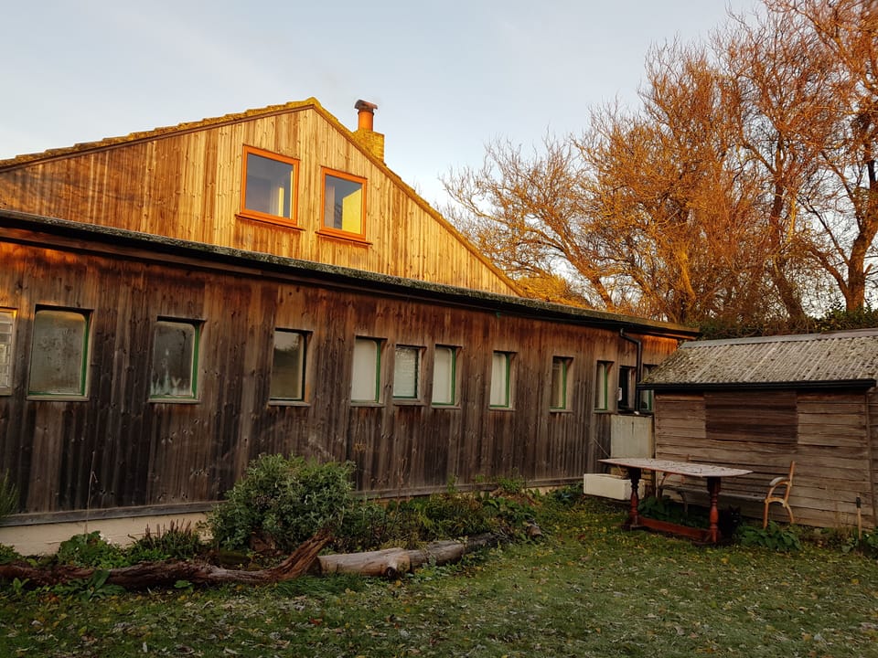 From the back garden. You can see how the railway carriage fits into the house.