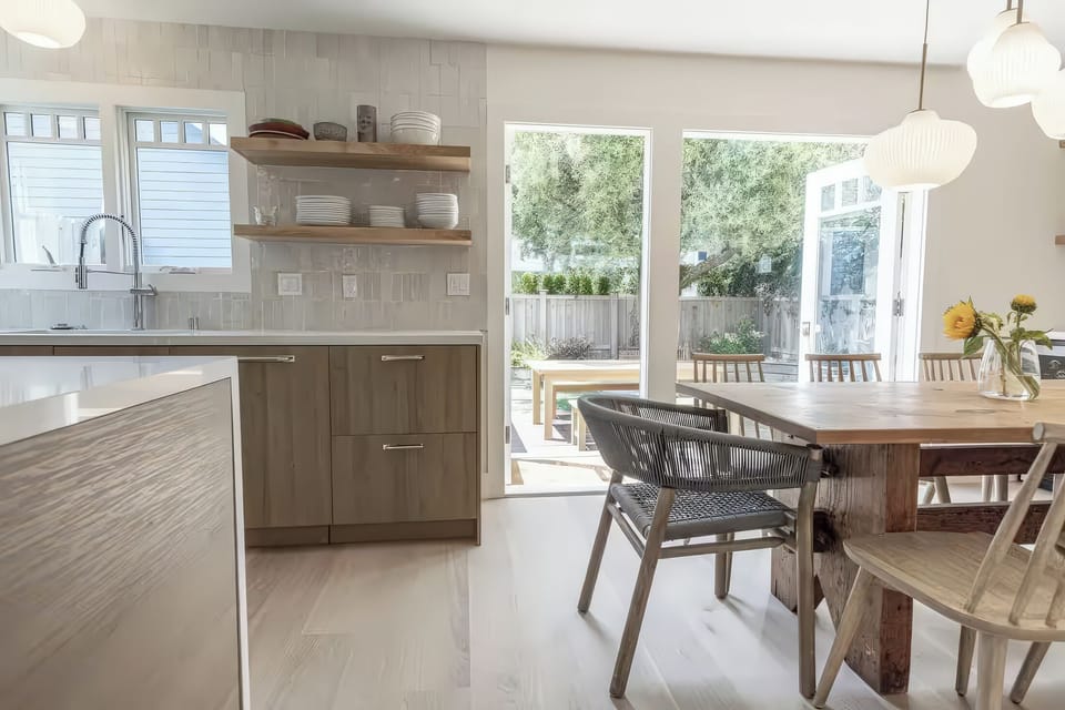 Dining area features French doors that open up to create indoor/outdoor dining.