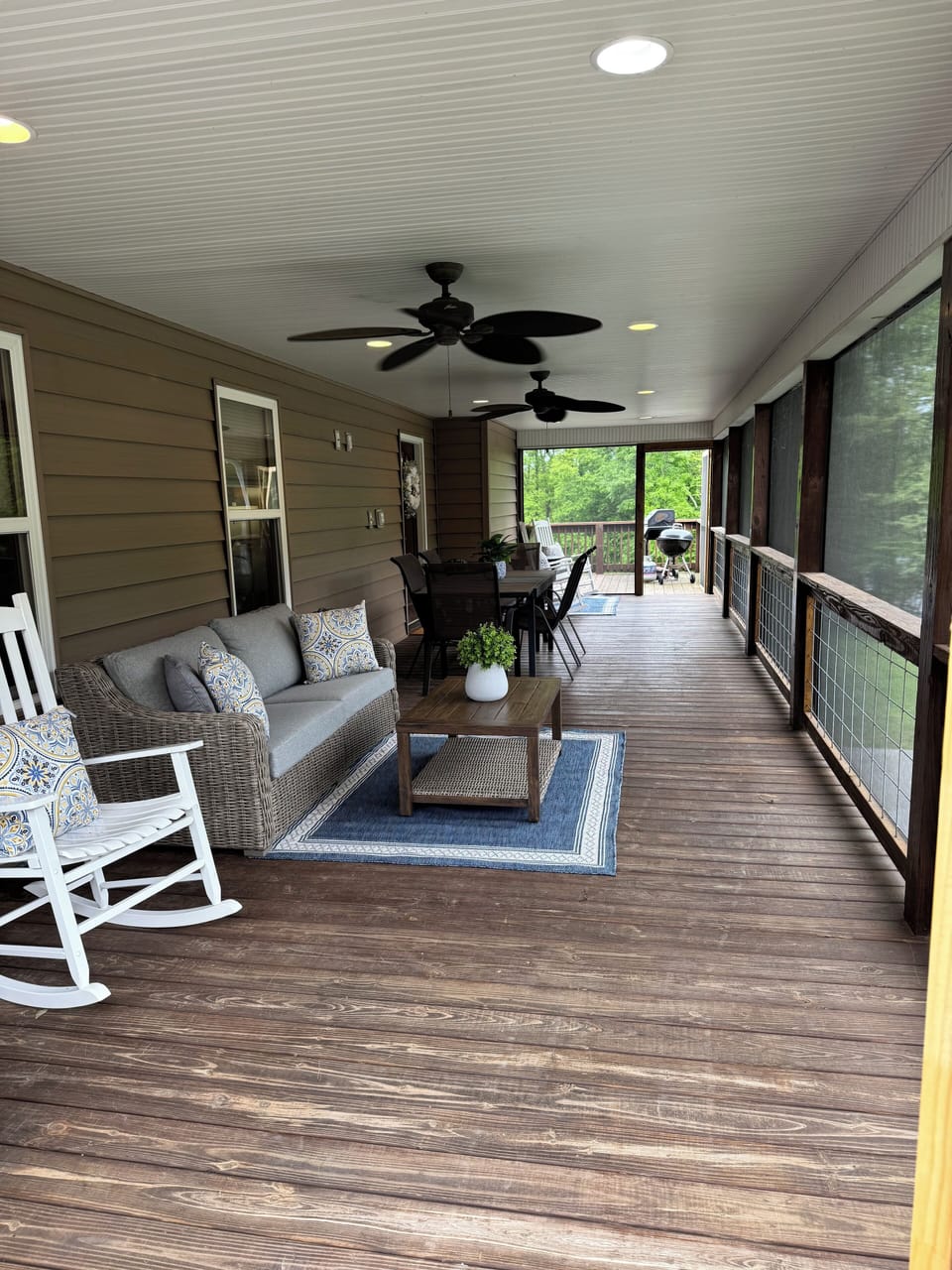 View of the screened in porch with several places to talk with friends & family