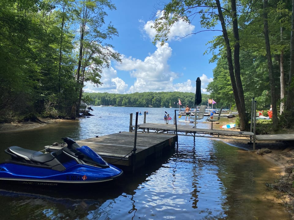 Summer view of our boat dock on the property (jetski not included in rental)