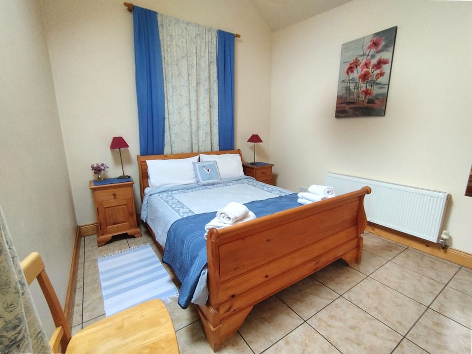 The bedroom has 5ft Sleigh Bed, wardrobe, drawers and garden view
