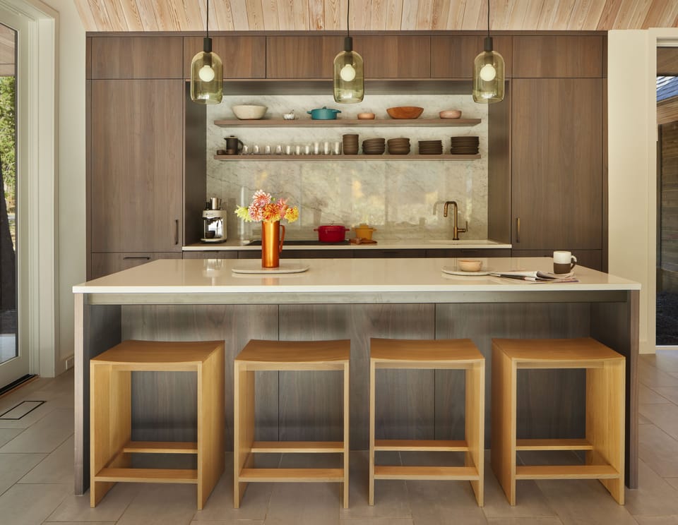 The kitchen features high-end appliances integrated into Henrybuilt cabinets.