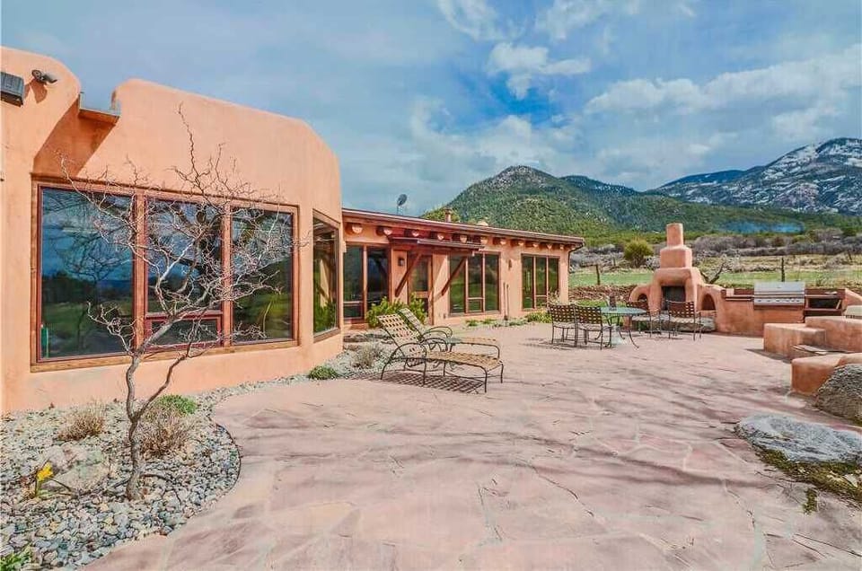 Soak up the gorgeous Taos skies and sweeping mountain views from the comfort of indoor or outdoor lounging and dining areas...complete with fireplace, grill and jumbo hot tub (not shown.)
