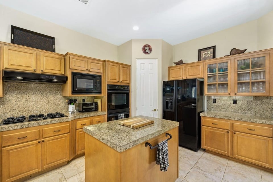 Bright, open & spacious chef's kitchen with five burner stove, and double oven