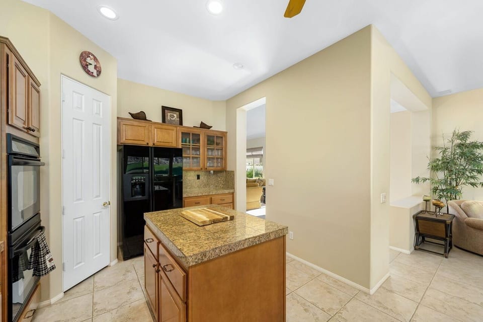 Kitchen island, refrigerator with ice/water in door and walk-in pantry.