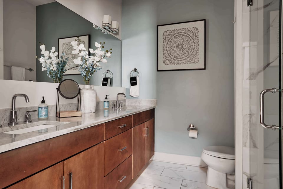 Unwind in this beautifully designed bathroom featuring a dual vanity, marble countertops, and elegant decor.