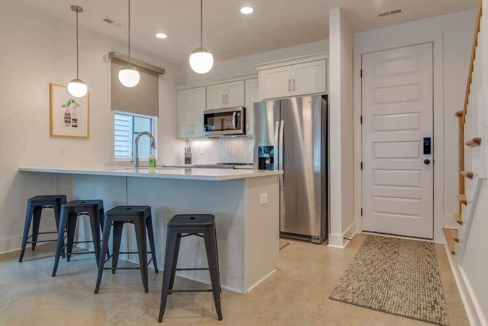 Craft delicious meals with ease in our fully-equipped kitchen, featuring a welcoming island bar perfect for both meal preparation and casual dining experiences.