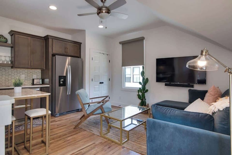 The kitchen, flowing seamlessly into the living room, makes entertaining effortless while creating a cozy and cohesive living space.