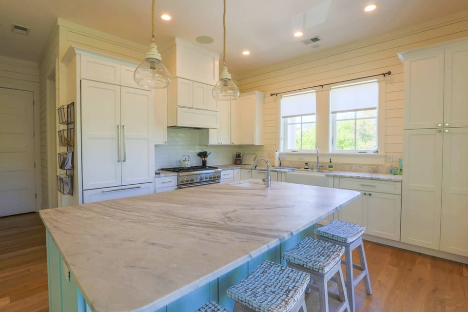 The gorgeous kitchen has a Thermador six-burner pro gas range and custom built-in Thermador refrigerator.