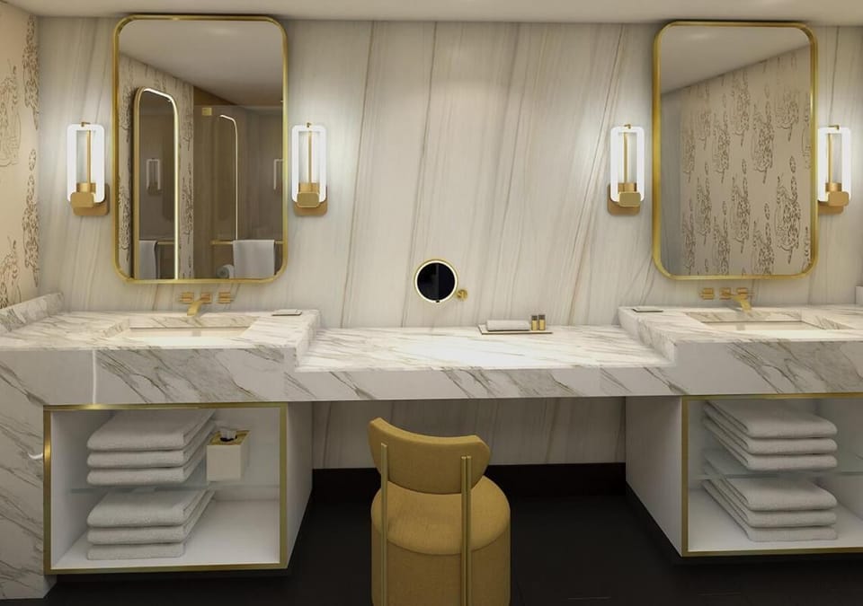 Refresh at the double vanity with marble and warm lighting.