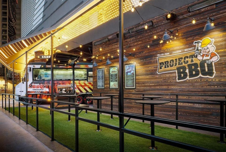 Enjoy open-air BBQ bites beneath twinkle lights outdoors.