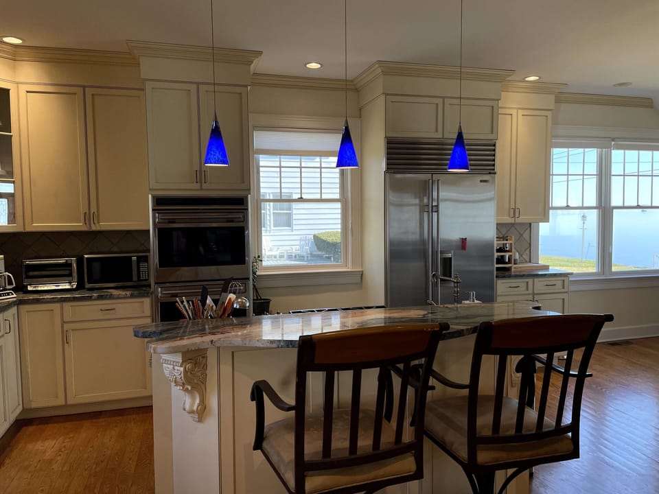 A delightful chef's kitchen with island, Wolf range and double ovens