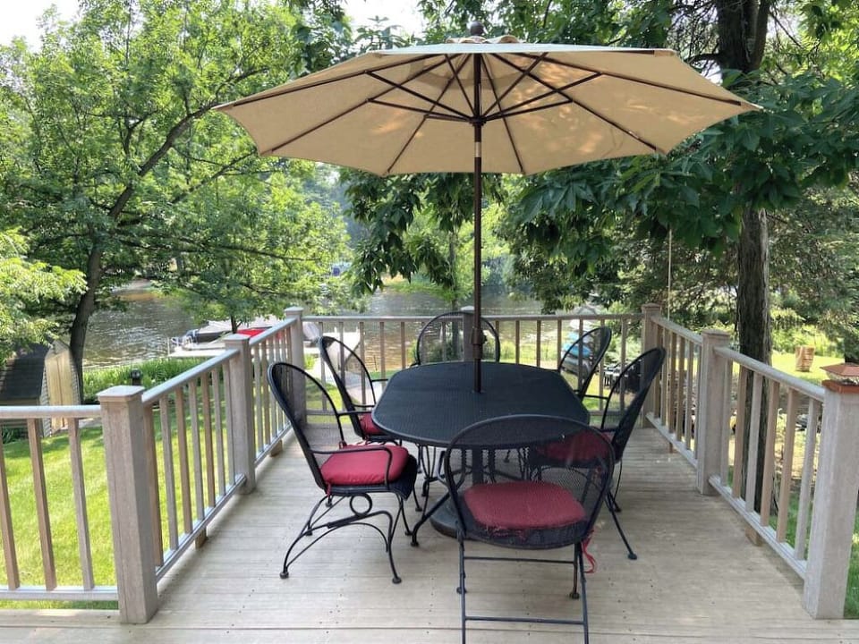 Spacious deck dining area overlooking the yard and water.