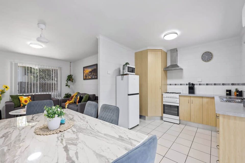 The kitchen is a highlight of the open-plan living area, offering a spacious and functional layout. It seamlessly connects with the dining and lounge spaces, making it perfect for socializing while preparing meals in a comfortable, airy environment.
