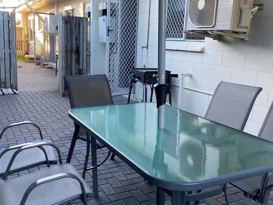 An outdoor area complete with BBQ, Table and Chairs and Umbrella for your private use.
