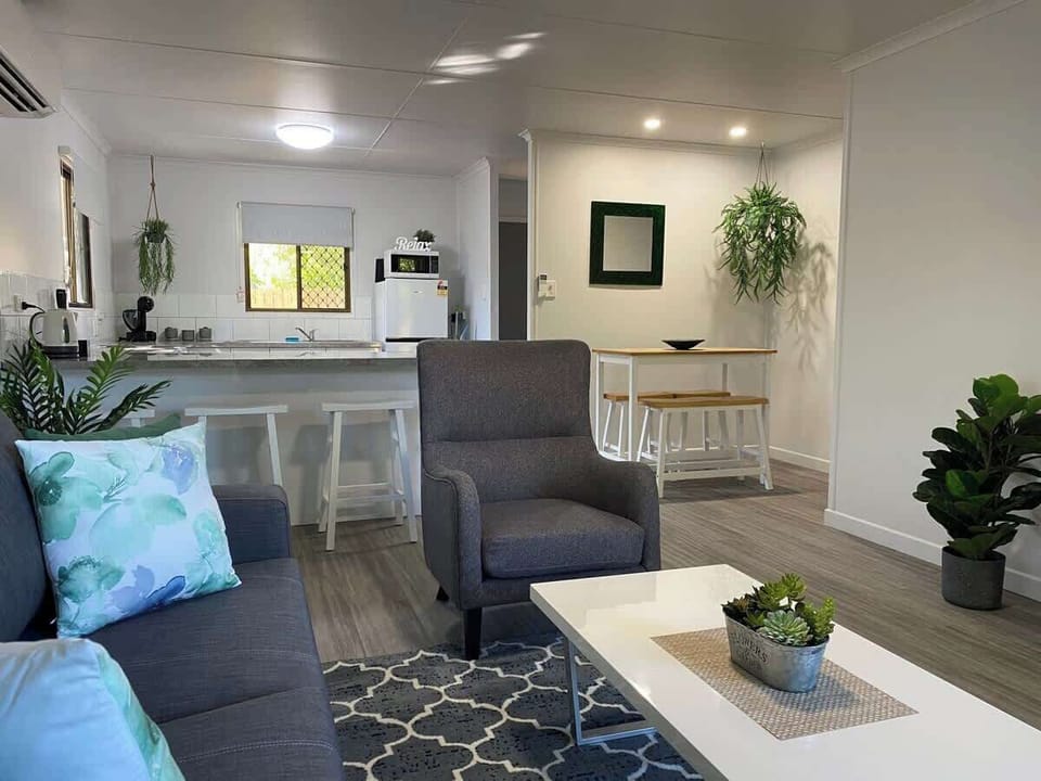 The cozy open-plan living area offers a warm, inviting space to relax. With comfy seating, air-conditioning, and a smooth flow between the lounge, dining, and kitchen, it's perfect for unwinding, socializing, or enjoying a quiet evening in.