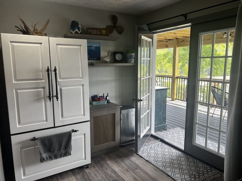 Extra basement refrigerator located just inside the screened in porch
