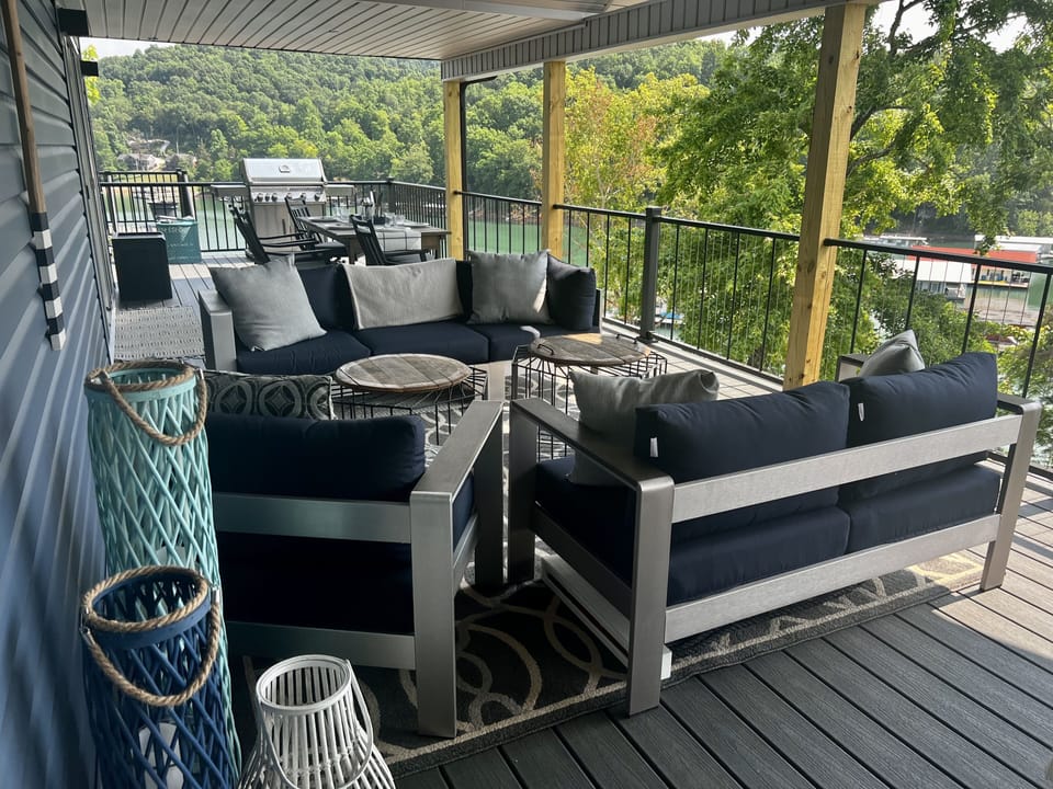 Upper Deck with couches, dining table, and grill