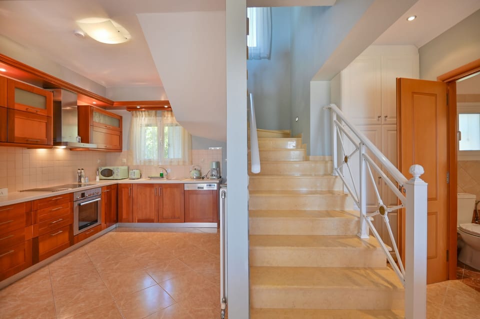 Kitchen and main staircase leading to upper floor