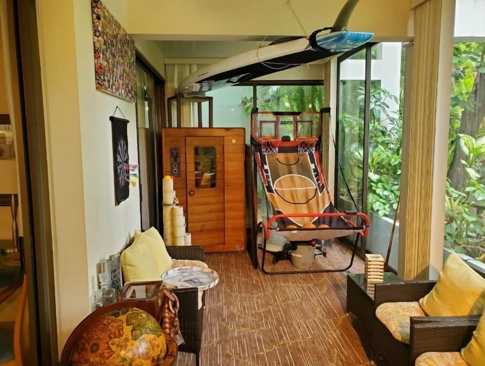 Spacious lanai with sitting area and beach equipment. 