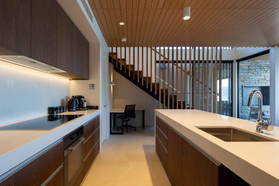 Modern Gourmet Space
This sleek, fully equipped kitchen features high-end appliances, a spacious island, and ample storage. Large windows provide natural light, with scenic lake and mountain views adding to the ambiance.