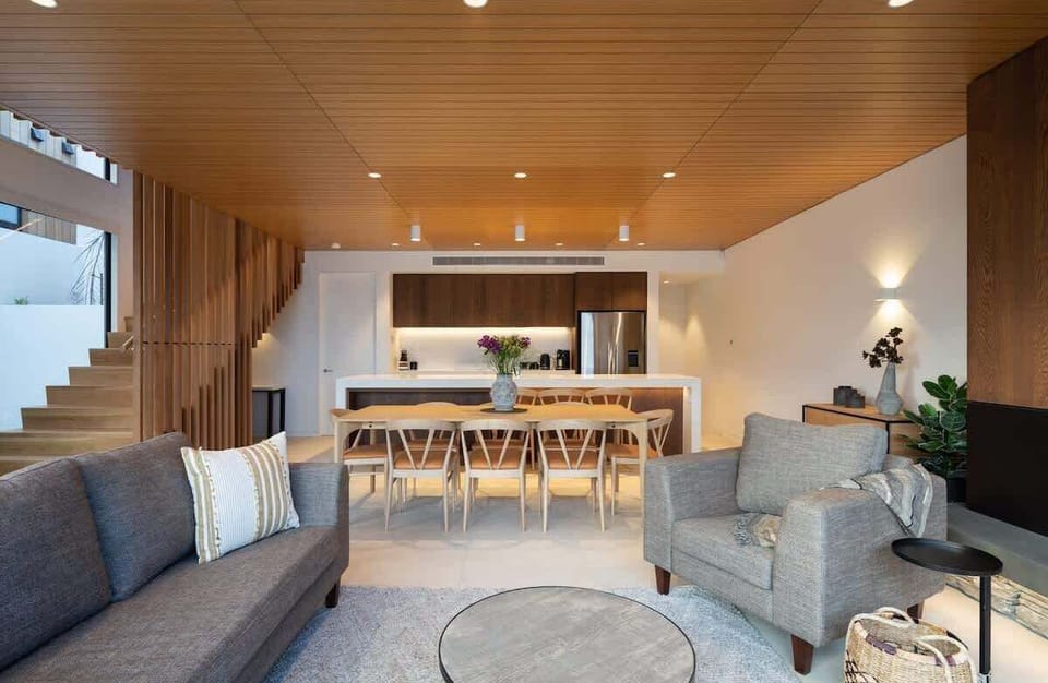 Stylish and functional, this modern living room features sleek furniture and sophisticated design. It seamlessly connects to the dining area, with large windows offering stunning views of Lake Wakatipu and the surrounding Queenstown landscape







