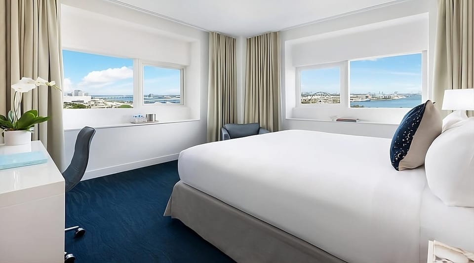 Wake up to sunlit linens and sweeping bay views.
