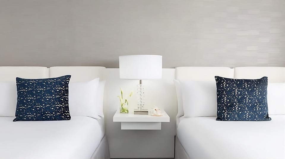 Sink into hotel-soft pillows under warm, restful bedside lighting.