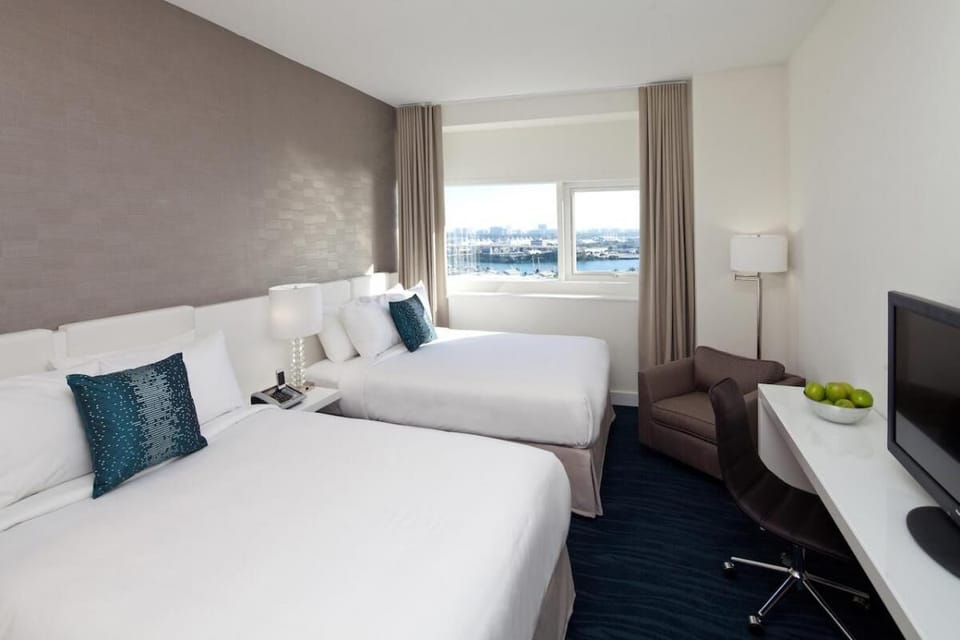 Unwind in crisp linens with soothing city-and-water views.