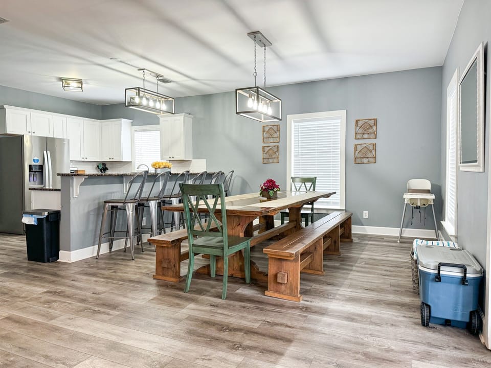 Large, custom-made dining table to accommodate your group with additional seating at the counter.  Note the high chair and the cooler for your convenience. Not many homes allow the whole gang to be together like this floorpan does!