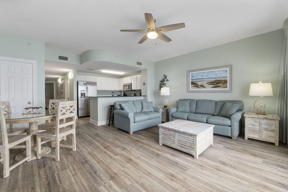 Open floor plan with living, dining, and kitchen all connected, featuring new stainless steel appliances