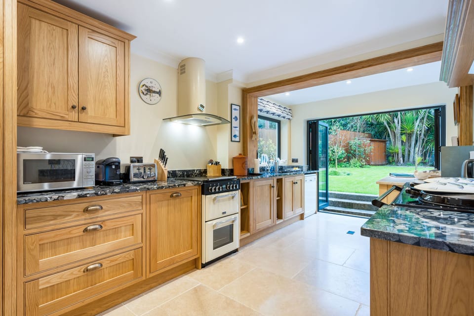 New handmade oak kitchen, granite worktops, bifold doors, electric oven, Aga.