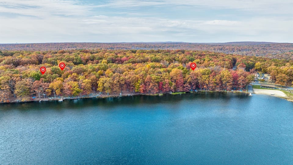 Vibrant red, orange, and yellow trees frame the lake in autumn!