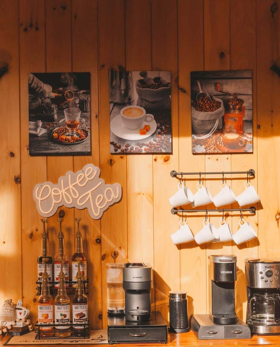 Coffee and tea station with a variety of options on wooden shelves