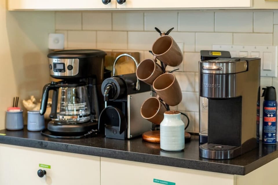 Mr Coffee for a crowd, Nespresso machine (pods provided), A smart Keurig that custom brews your selection (regular, decaf, flavored, tea...) .  Not shown but here:  A French press and pourover cone, and half-and-half and creamer.You need your coffee!