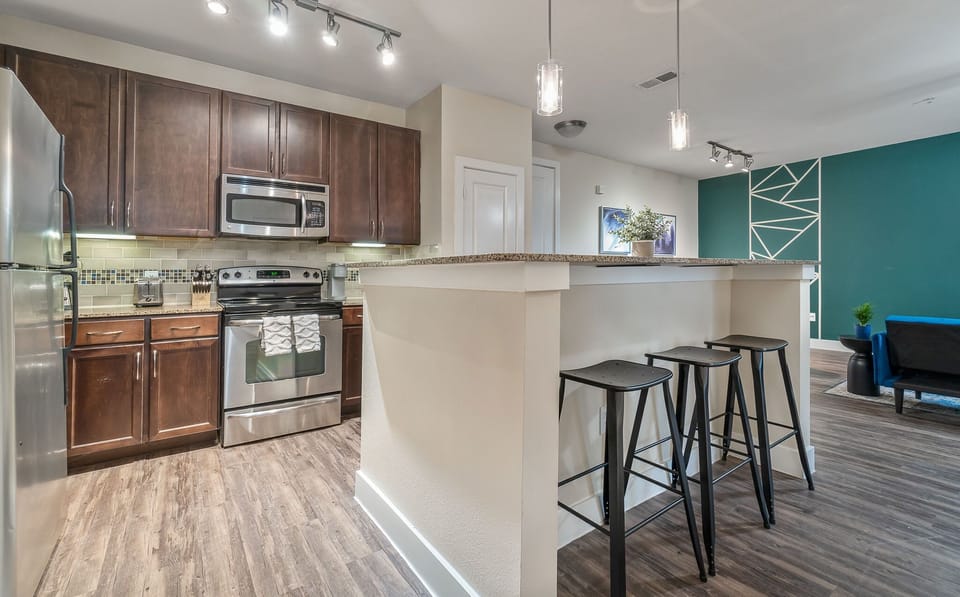 Large fully stocked kitchen with bar height island.
