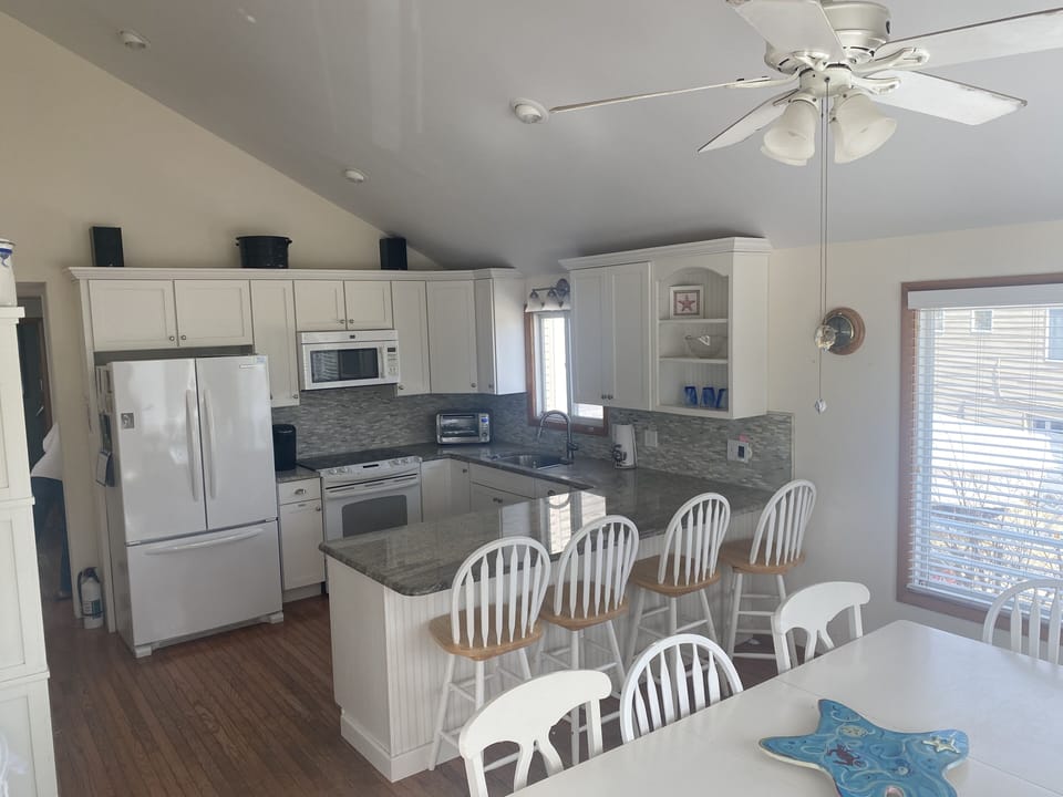 Kitchen has granite counter tops and the table is plenty big for family games