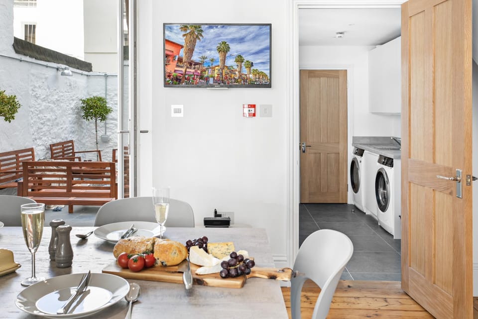 Kitchen leads to the utility room with AEG washer, dryer, iron, steamer, etc.