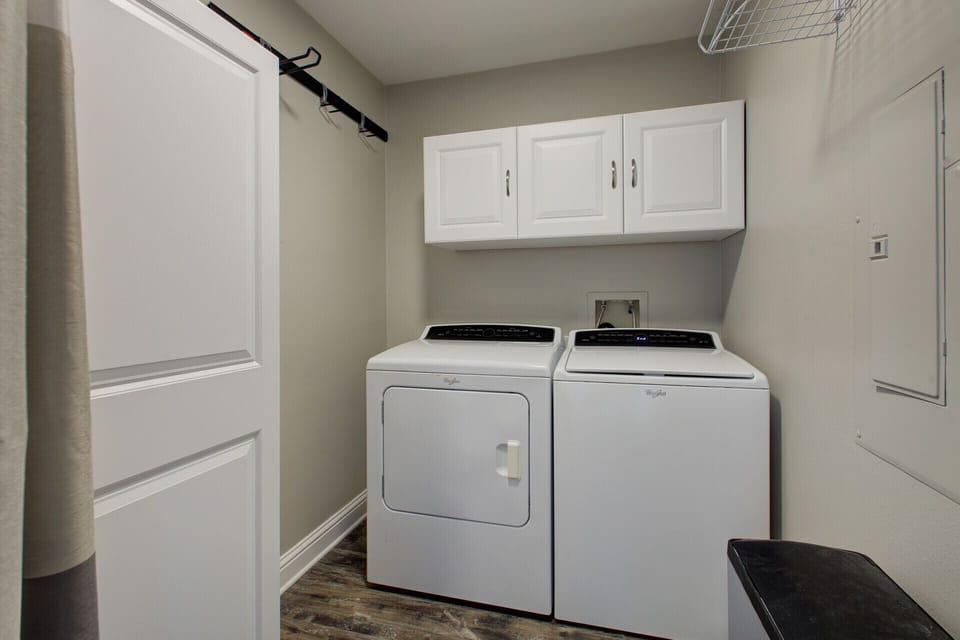 Laundry room immediately to the left of the unit entrance.