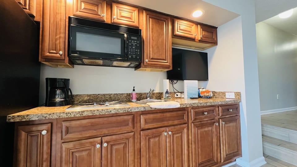 Kitchen: refrigerator with ice maker, stovetop, microwave, sink