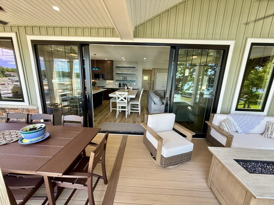 Sixteen foot sliding doors open the great room to lakeside living.