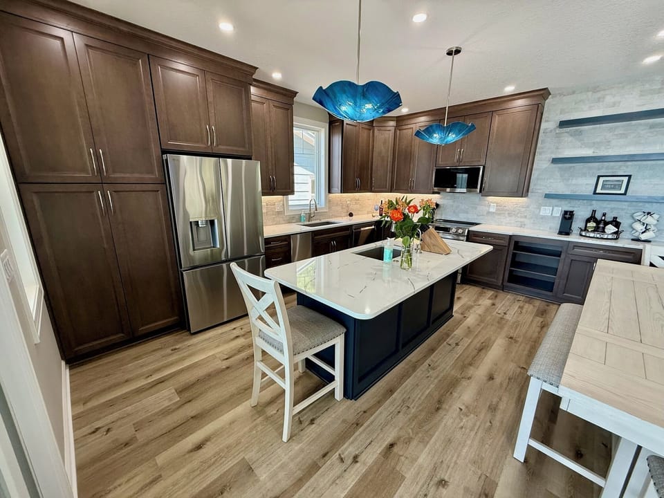 Maple cabinetry, quartz counters, and hand blown glass pendants.