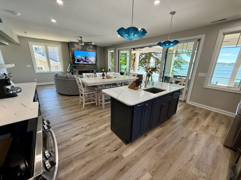 Open kitchen island flowing into dining and lake views