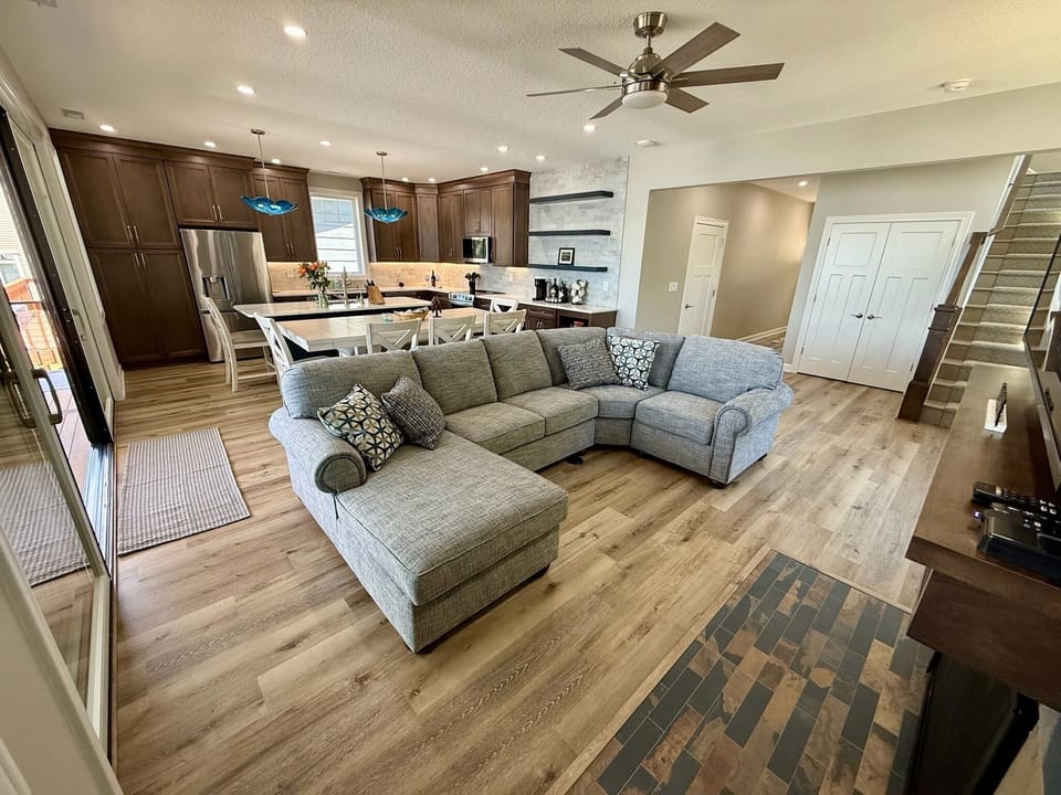 Spacious open-concept living with sectional seating and new 70" Roku TV