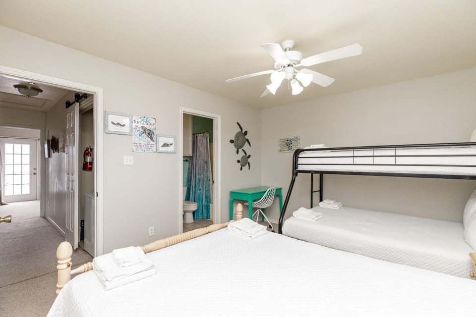 Your guest bedroom features a queen bed and twin over full bunk bed.