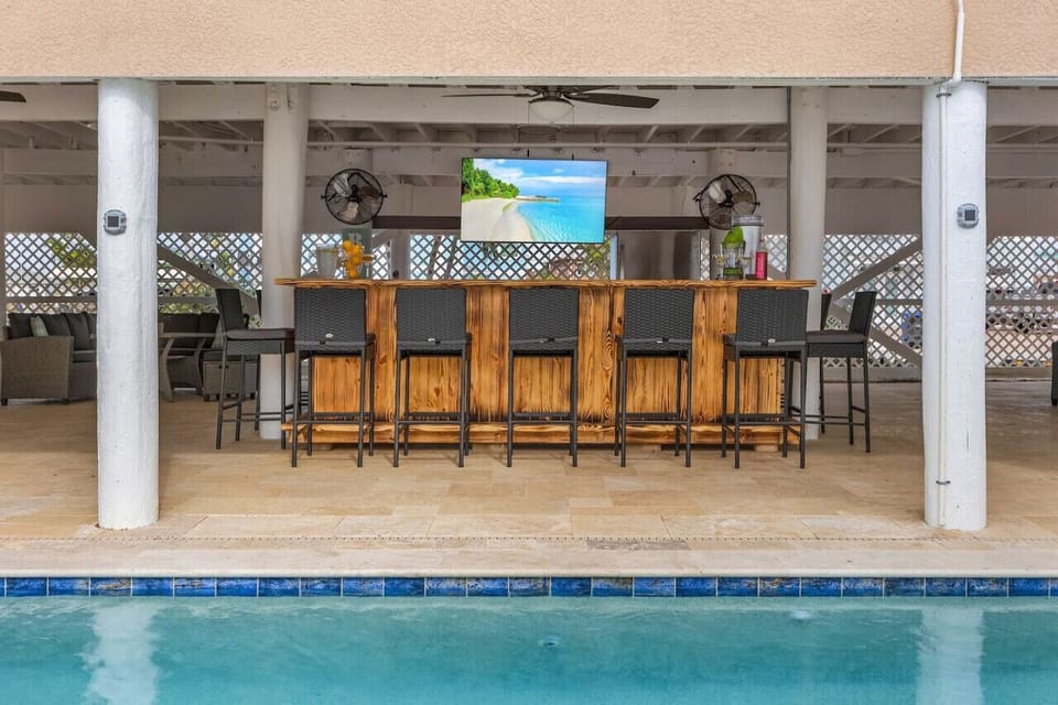 The downstairs pool deck and pool bar is a fantastic space to enjoy outdoor Florida living.